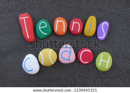 Tennis coach text with colored stones over black volcanic sand