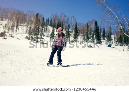 Photo of snowboarding female during vacation on winter resort