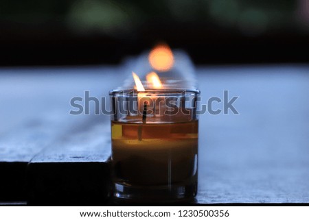Glass candle with it's reflection,The symbol of prayer