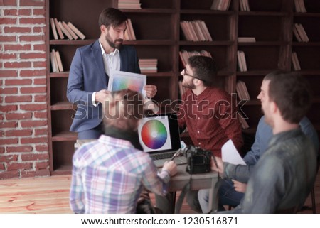 group of creative designers discussing the color palette