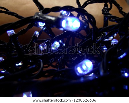 Close up photo about a light garland with cold blue light.