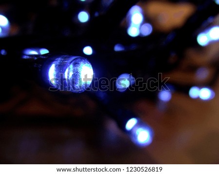 Close up photo about a light garland with cold blue light.