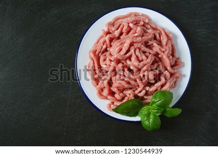 minced meat on black stone surface