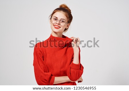 Joyful fashionable woman in a red sweater                    