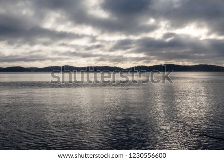 Calm waterscape with clouds above