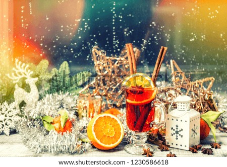 Christmas window decoration. Mulled wine with fruits ans spices. Vintage style toned picture