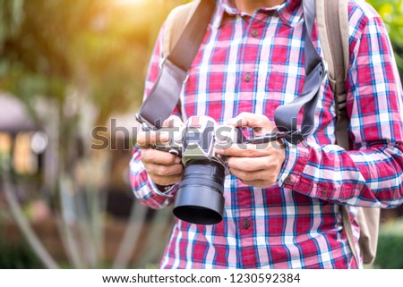 Professional photographer holding camera on hands