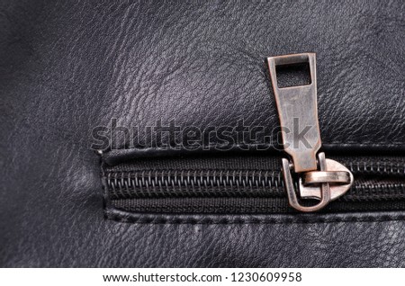 Black leather material texture fashion zipper accessory fittings on background