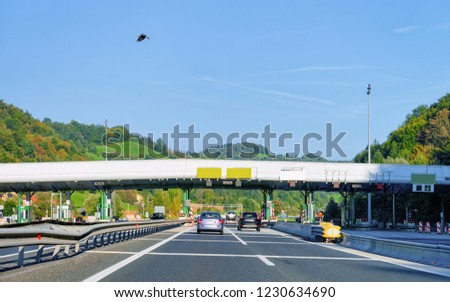 Cars at Toll booth with Blank signs on the road, in Slovenia.
