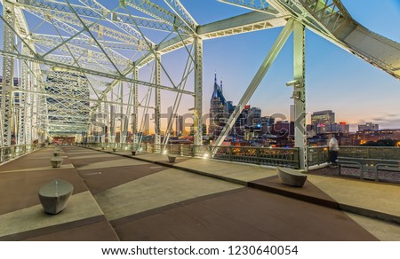 Nashville Skyline from John Seigenthaler Pedestrian Bridge at Dusk Royalty-Free Stock Photo #1230640054