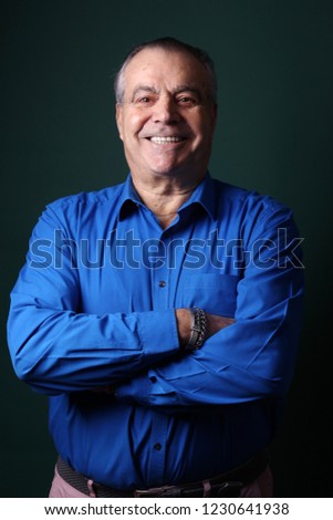Older man in front of a colored background