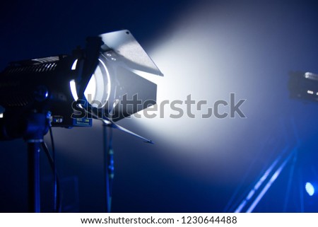Film light on dark blue background with smoke