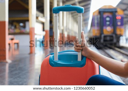 Woman Hand holder luggage at train station