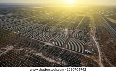 Aerial solar photovoltaic panels in the morning, exposed to direct sunlight