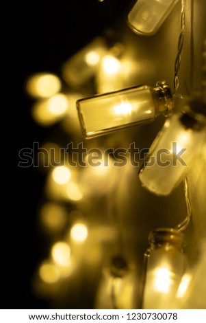 Holiday and Christmas lights (Many yellow LED fairy string lights create light and shadow on clear black background)