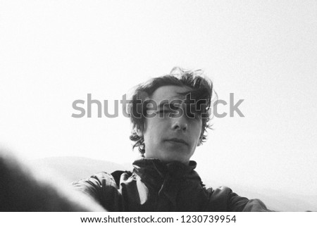 Handsome guy takes a selfie. Black and white photo. The man took a random selfie. Royalty-Free Stock Photo #1230739954