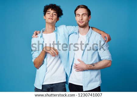 two men in shirts hug                         