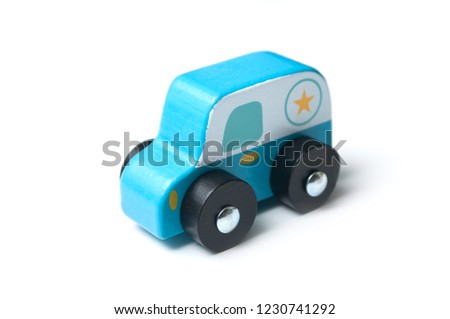 closeup of blue miniature wooden car on white background - concept police patrol