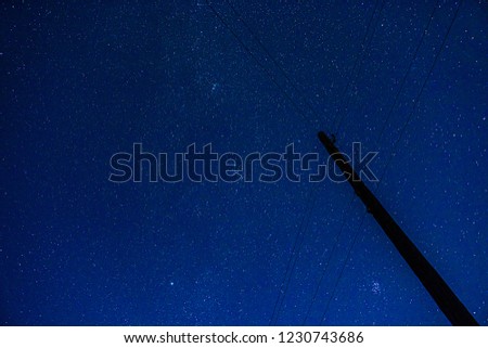 Starry sky and pole with power line