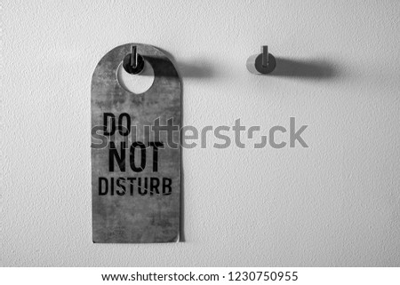 Do not disturb sign on the white wall