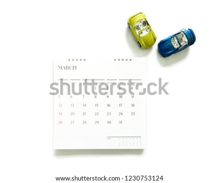 Calendar and car models on white background for planning of car maintenance .