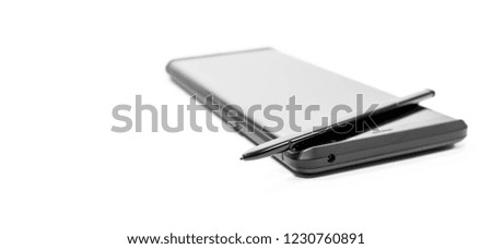 Modern mobile phone with stylus in black and white isolated on white background, space for text.