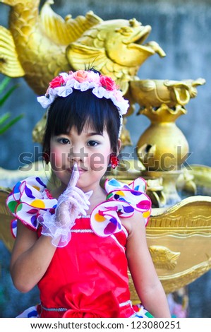 Cheerful little asian girl wearing colourful dress