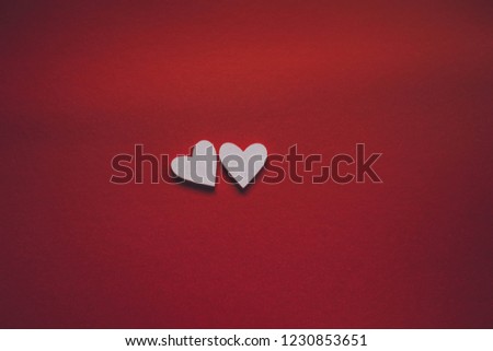 Two white hearts on a red background to the day of Saint Valentine