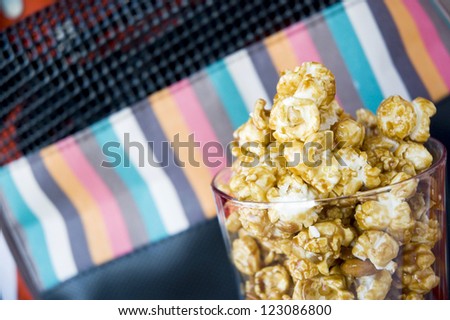 close up caramel popcorn in glass with colorful background