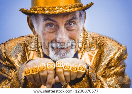 Funny and extravagant senior man posing on colored background - Youthful old man in the sixties having fun and partying Royalty-Free Stock Photo #1230870577