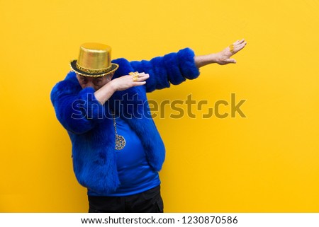 Funny and extravagant senior man posing on colored background - Youthful old man in the sixties having fun and partying Royalty-Free Stock Photo #1230870586