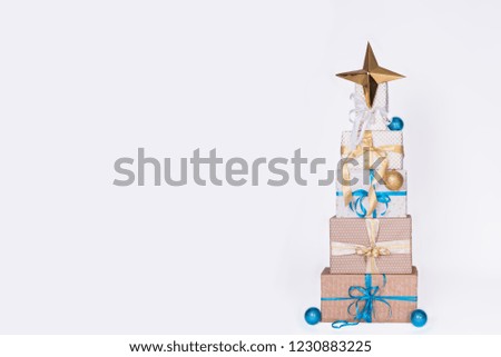 Christmas gift boxes laid out in the shape of a Christmas tree on white background. Xmas. family holiday concept. Merry Christmas and Happy Holidays.
