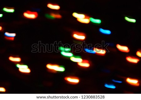 Long exposure. Colorful lights bokeh background, Chrismas lights bokeh. Colorful abstract background. Blurred and glowing lights. Boceh lens effect from lighting spots.