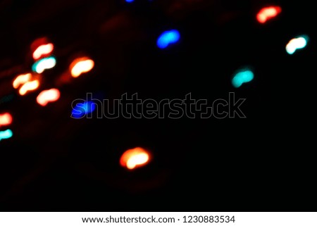 Long exposure. Colorful lights bokeh background, Chrismas lights bokeh. Colorful abstract background. Blurred and glowing lights. Boceh lens effect from lighting spots.