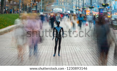 The dummy standing on the street among the stream of people