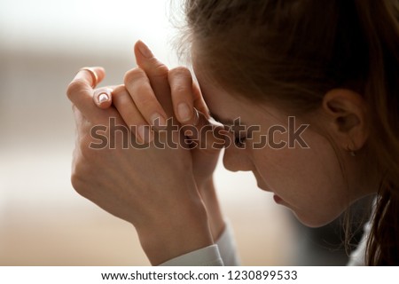 Close up of upset woman feel down and sad having life or relationships trouble, frustrated female with eyes closed in despair think of problem solution, hurt girl heartbroken after breakup or bad news Royalty-Free Stock Photo #1230899533