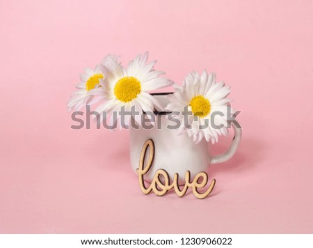 Creative paper background with stamp love and flowers in white mug. Pink trendy color.Holiday and celebration concept for postcard or invitation,copy space