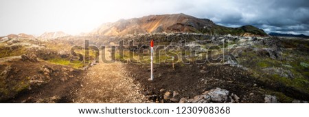 Hiking trail and a marker in beautiful colorful volcanic mountains Landmannalaugar in Iceland, summer time