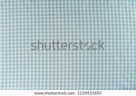 Mint and white is the checkered pattern on a tablecloth. The fabric is woven and is wrinkle free.



