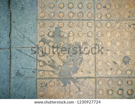 top view dirty braille brick surface texture, dripping paing on yellow pathway block background