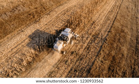 Close up details and aerial view of combine harvesting