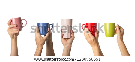 Many different hands holding multi colored cups of coffee on a white background. Female and male hands. Concept of a friendly team, a coffee break, meeting friends, morning in the team. Banner Royalty-Free Stock Photo #1230950551