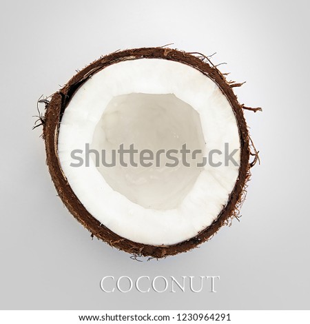 one half of ripe coconut on a gray background,close up and top view