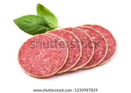 Sliced Italian Homemade Salami. Salami in Cheese with basil leaves, isolated on a white background. Close-up
