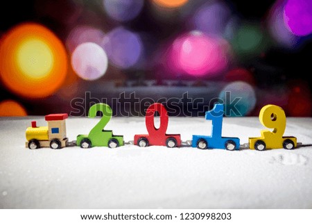 2019 happy new year,wooden toy train carrying numbers and Cristmas tree,covering snow. Holiday concept