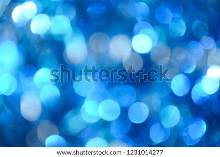 Bokeh photo. Holiday background. Christmas lights. background. Defocused sparkles. Blue bokeh. New Year backdrop. Festive wallpaper. Blinks. Carnival. Retro style photo. Blue.