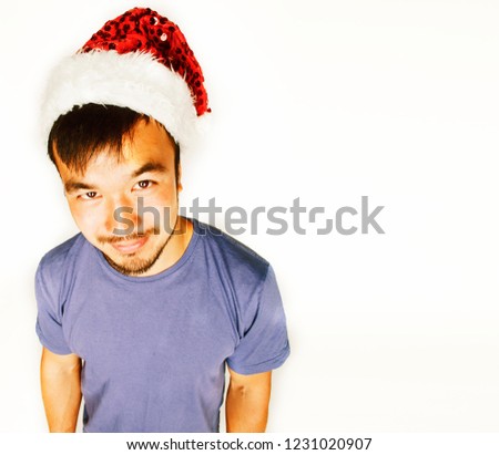 funy exotical asian Santa claus in new years red hat smiling