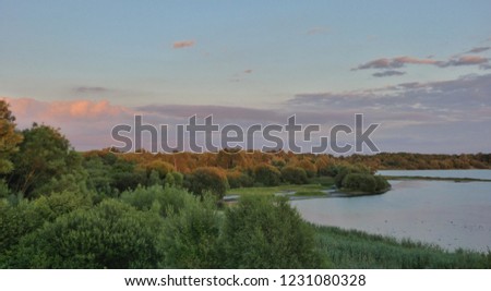 Incredibly beautiful day with sun, sky, lake. Sunset or sunrise landscape, panorama of beautiful nature. Blue Sky with amazing colorful clouds, water reflections. Dream views. photo taken in the UK.