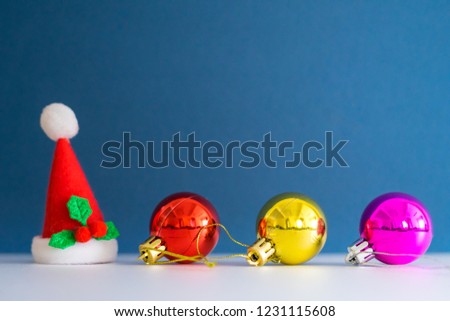 Small Christmas hat on white table with blue background.Christmas concept with copy space.