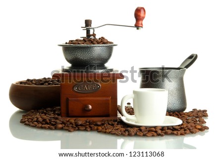Coffee grinder, turk and cup of coffee with beans isolated on white